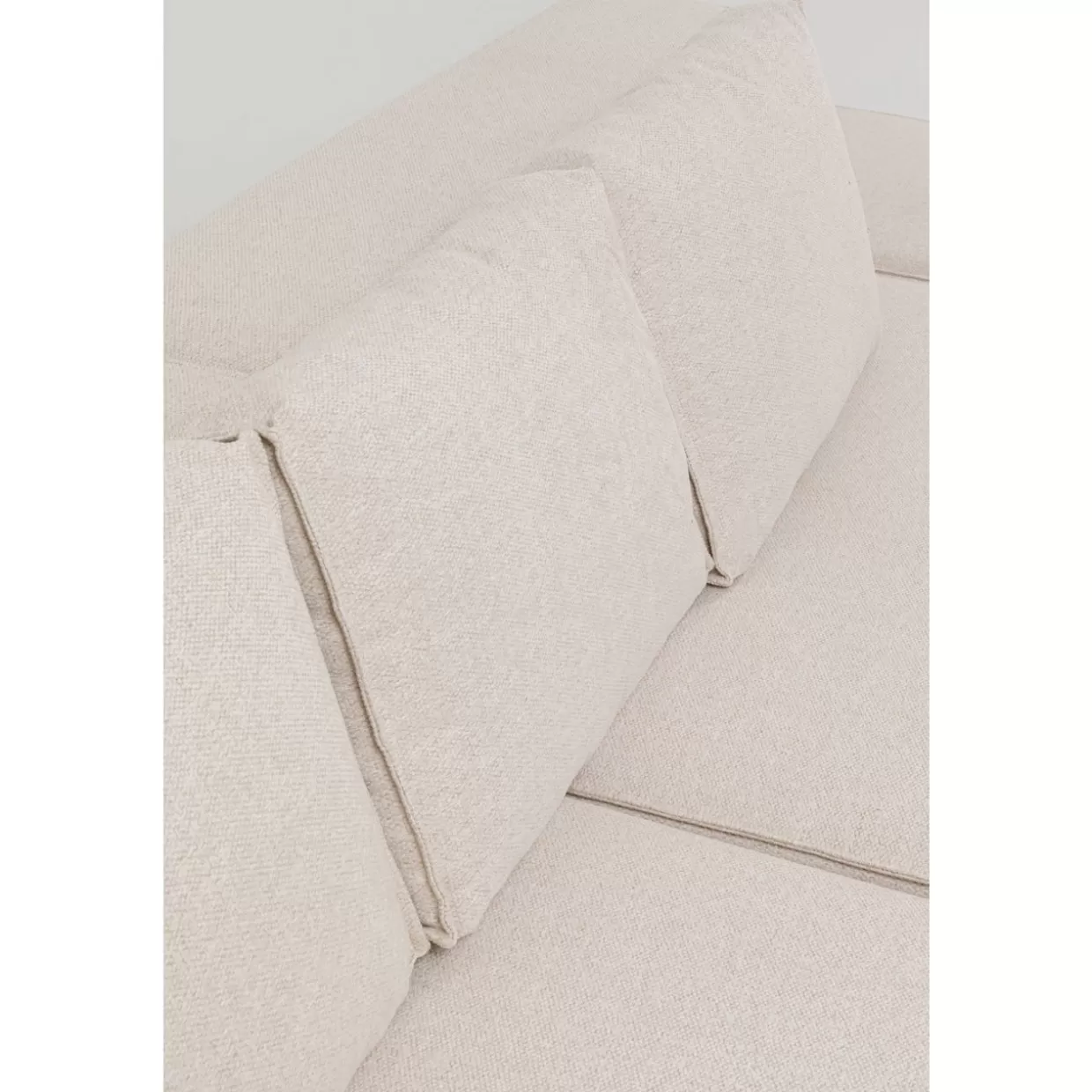 Divano angolare Infinity con poggiapiedi integrato in tessuto crema chiaro - Design moderno KARE